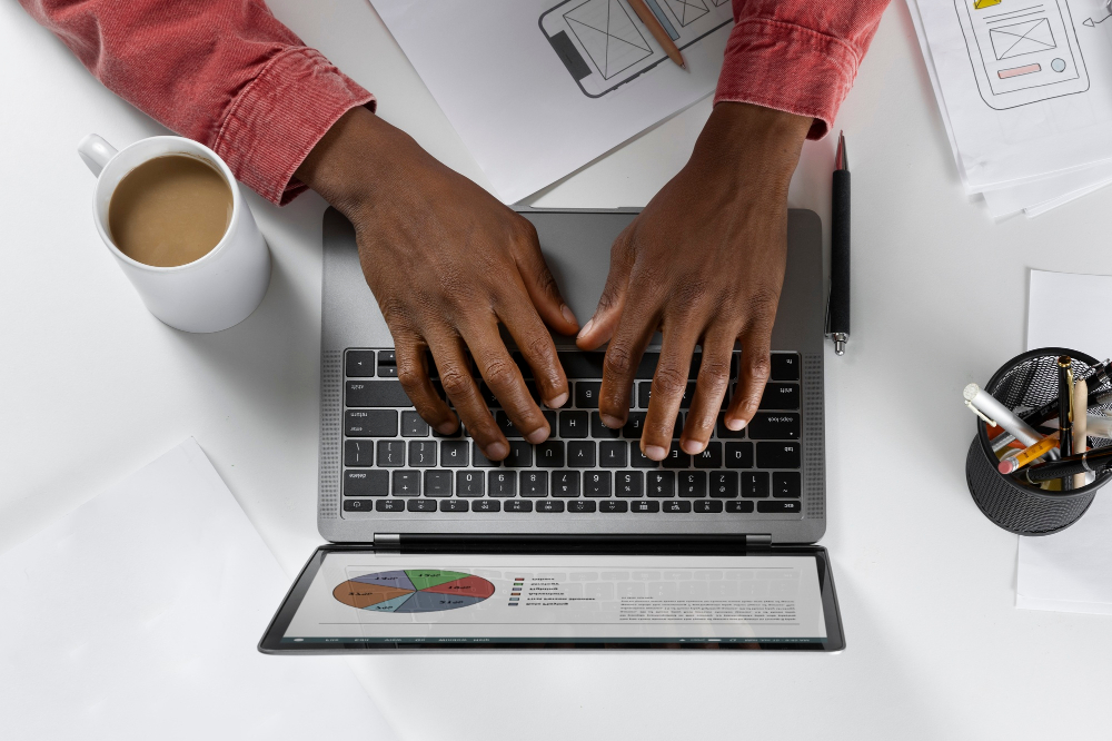 African descent typing on laptop with coffee next to him | Netsheria Legal documents customization