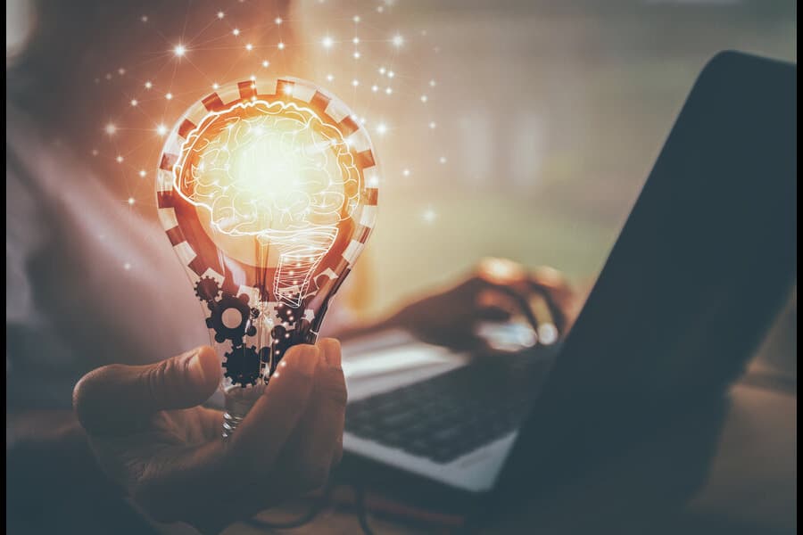 Man holding a virtual global internet technology on his hand with laptop open | Netsheria Intellectual Property